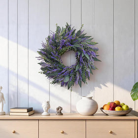 Zhoree lavender eucalyptus wreath used as a wedding backdrop accent.