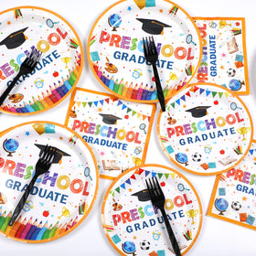 ZOIIWA preschool-grad-hats-trophies-decor: Festive hats and trophies add celebratory vibes to the table.