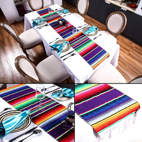 Zonon table decor setup with runner and fans for indoor celebrations.