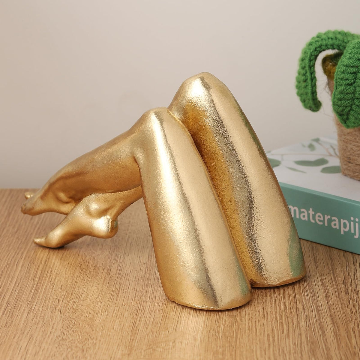 Zonsuli Golden Legs sculpture with porcelain-look finish complements coffee tables and shelves.